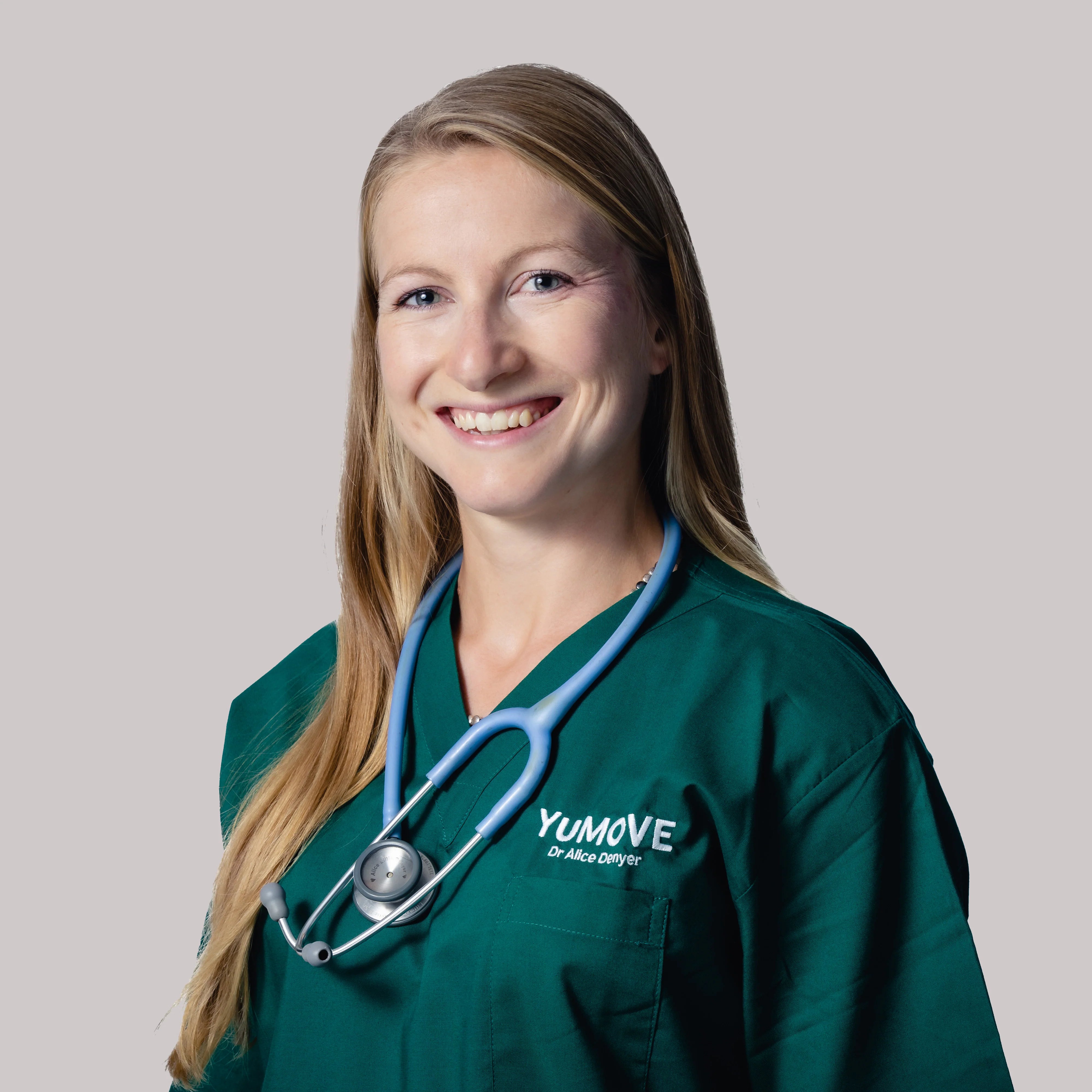 This image is of Dr. Alice Denyer, Veterinary Technical and Research Manager at YuMOVE, wearing green YuMOVE branded scrubs and a stethoscope in front of a plain white background.